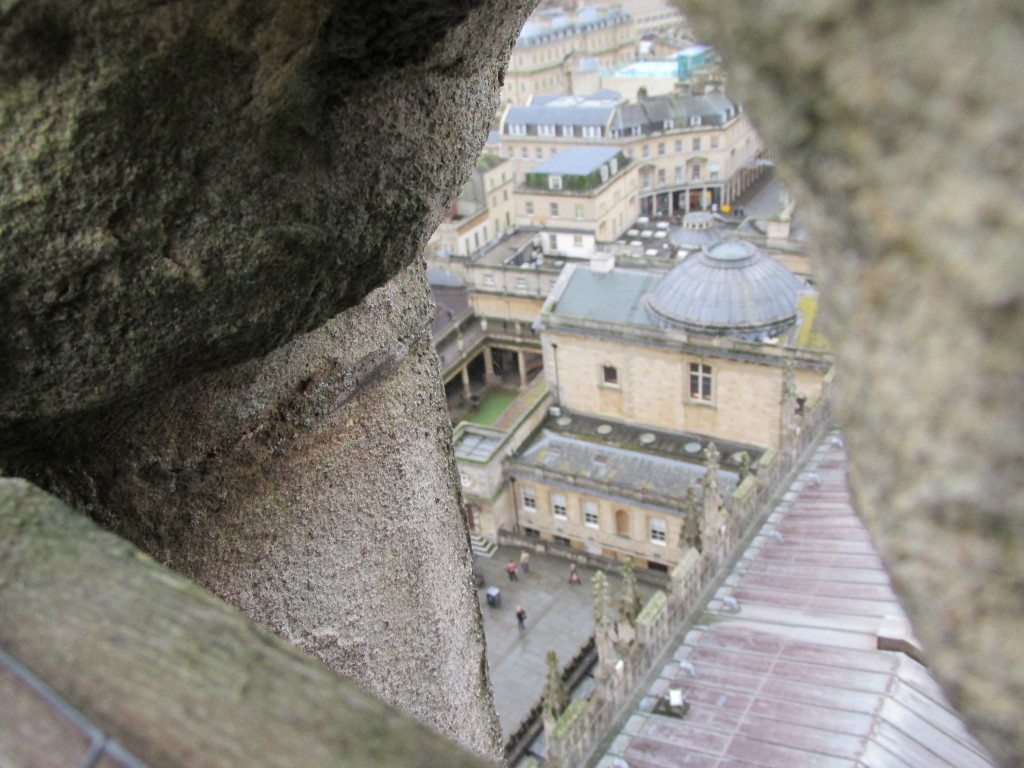 View of the Roman Baths through the stones of Bath Abbey Tower