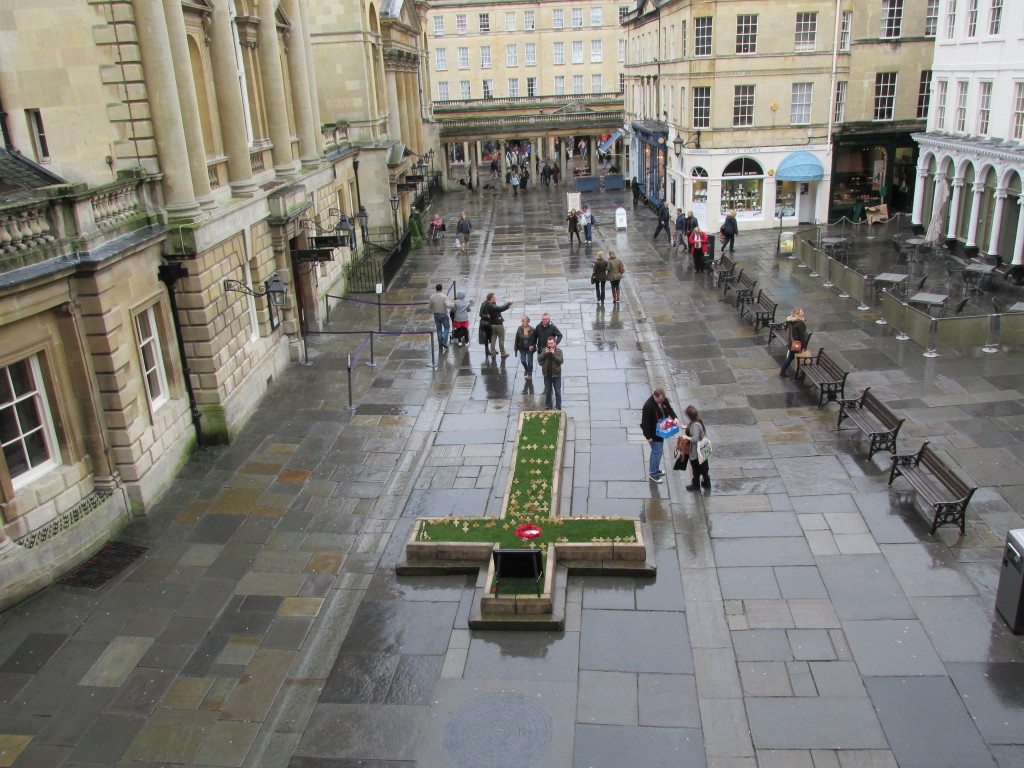 View of the square between Bath Abbey. The Roman Baths are on the left and Stall Street is directly ahead. We were there in early November and the grass cross in the middle of the square contained markers with names of soldiers for Remembrance Day.